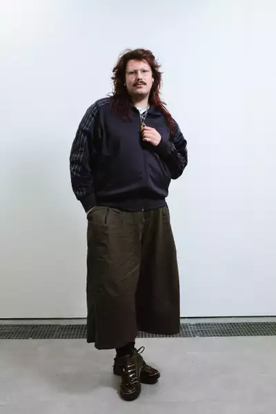 Spencer Dent wearing a black Adidas jacket and dark green trousers