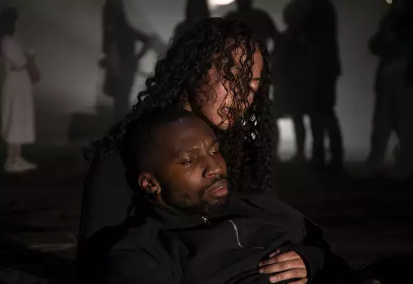 A photo of warehouse industrial space with a woman holding a man in her arms