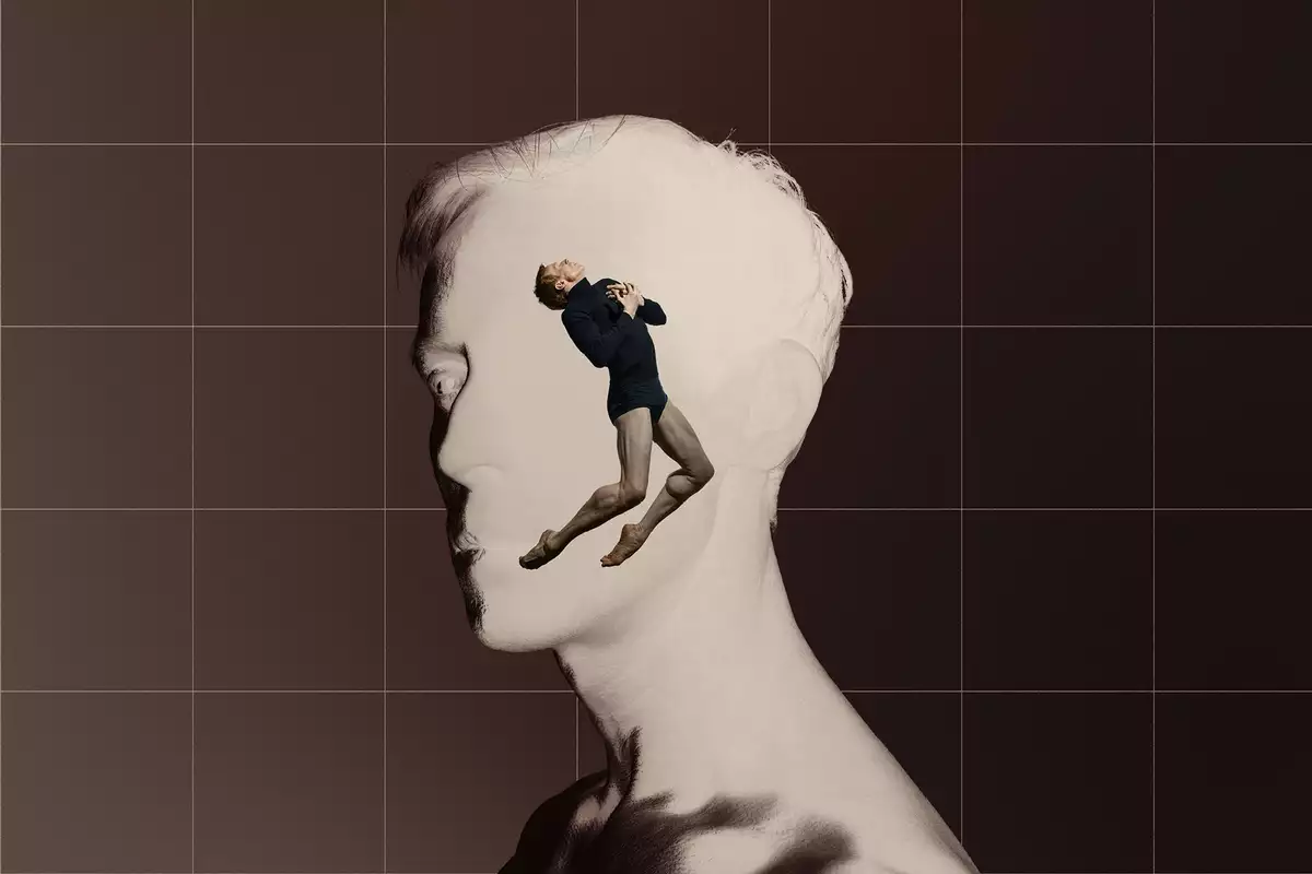 A digital collage features a grayscale side profile of a man's face, with a dancer emerging from within, positioned in a dramatic pose. The background is divided into a warm brown and a grid-like structure, enhancing the contrast between the two figures.