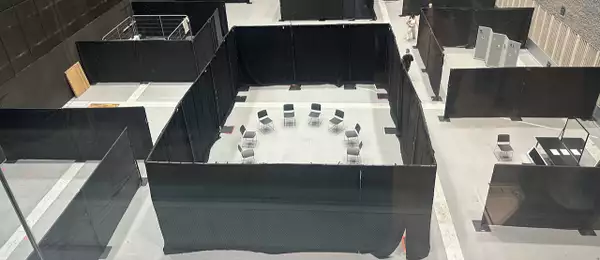 A photo of the various stations in the Warehouse, taken from above. It shows sectioned areas.