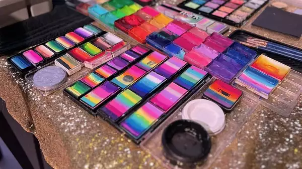 A selection of colourful face paints on a table
