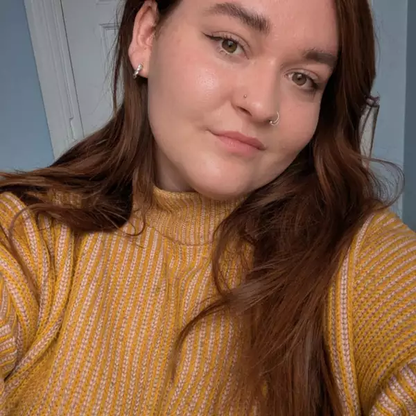 Headshot of Amie Kirby wearing a yellow jumper