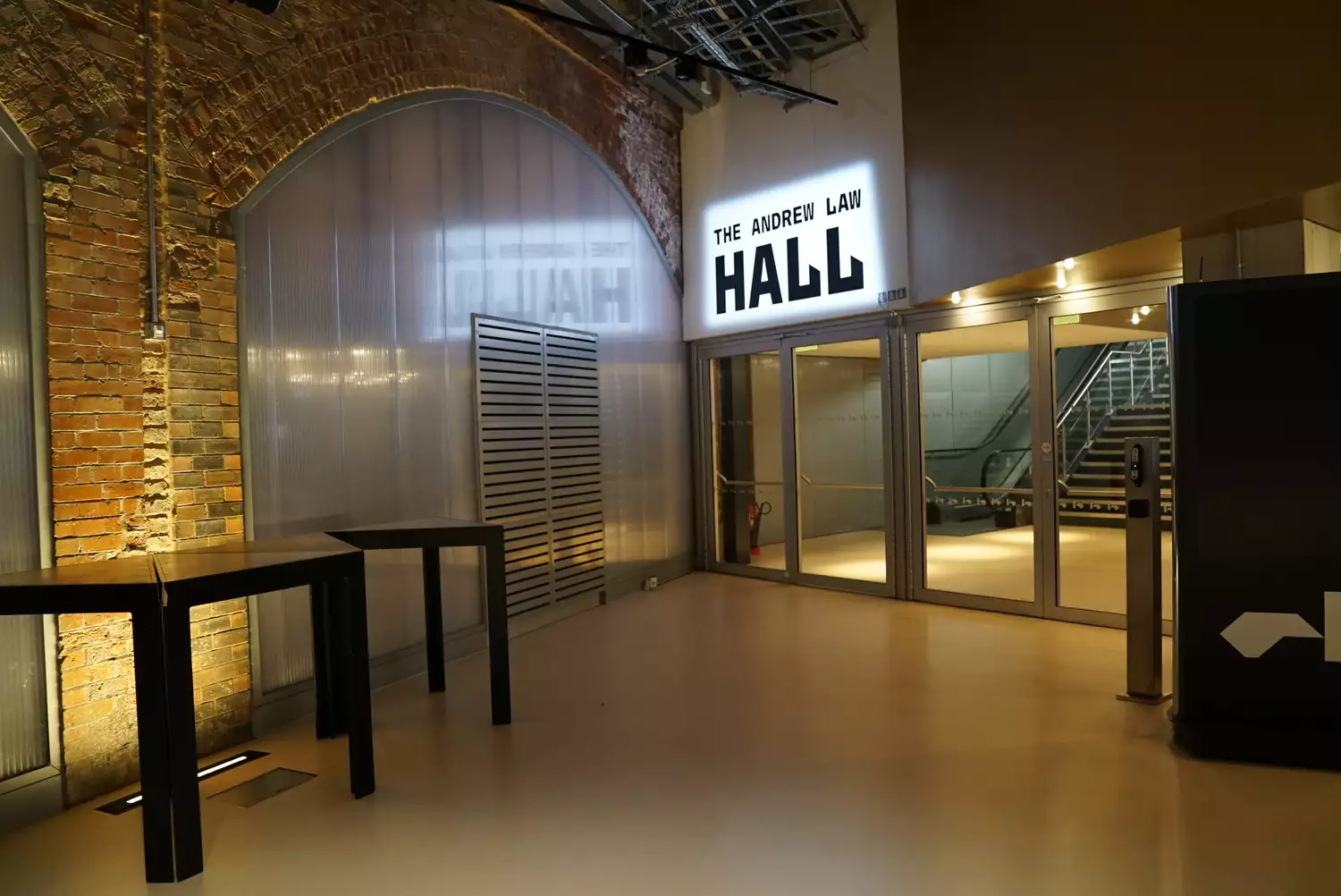 The doors leading into the Hall, with the words The Andrew Law Hall lit-up above them