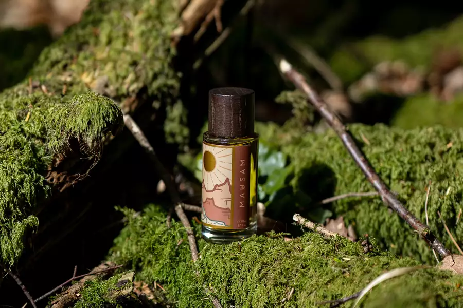 A perfume outside on a mossy tree branch