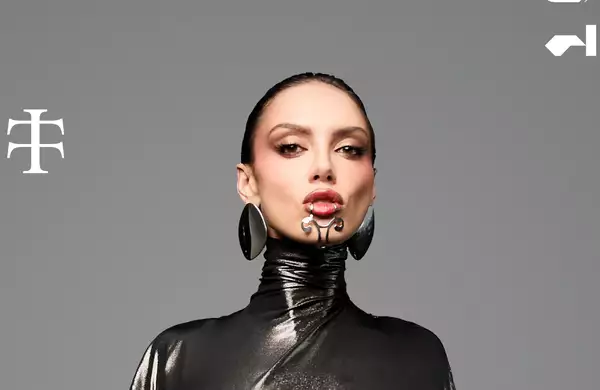 Sara Landry on a grey background wearing black leather