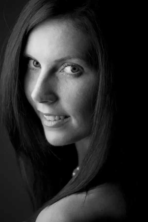 Black and white photos of Kristen McNally smiling