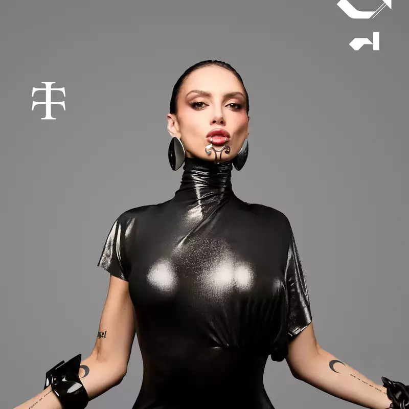 Sara Landry on a grey background wearing black leather