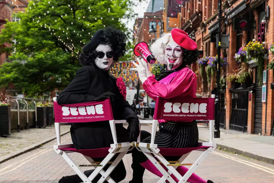 Two people sat on SCENE Festival branded chairs on Canal Street