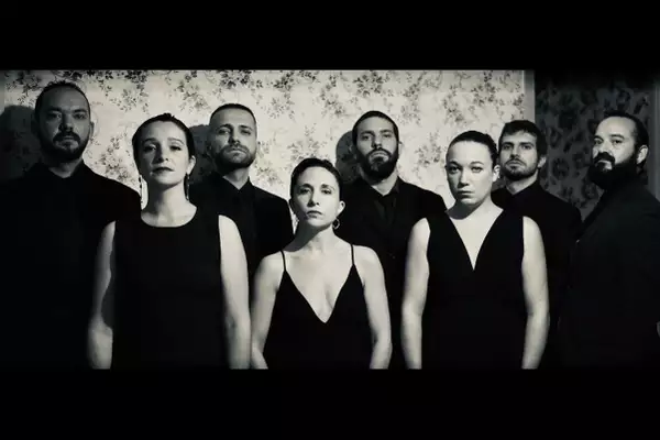 Eight members of Barrut wearing all-black – the photo is black-and-white