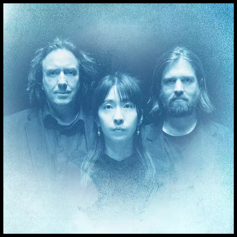 Thorsten Quaeschning, Hoshiko Yamane and Paul Frick on a gradient blue-toned background, which resembles the album cover for Phaedra.