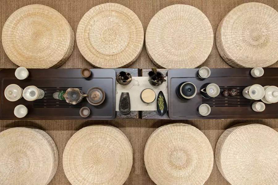 A traditional Chinese table laid with mats and tea pots