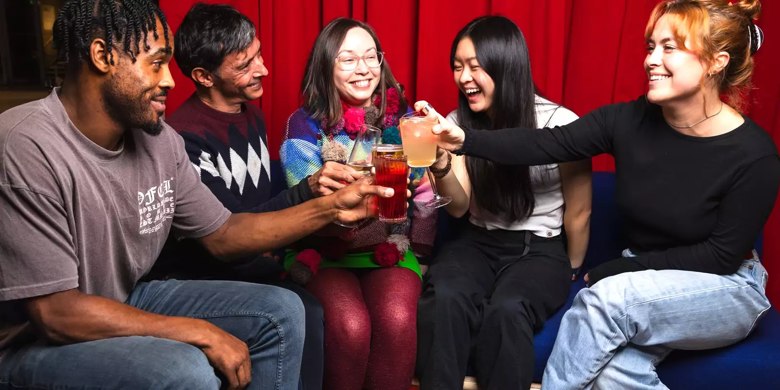 A group of people inside Aviva Studios drinking.