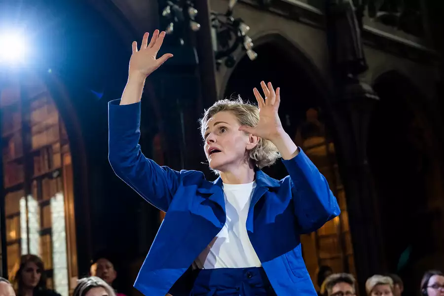 Maxine Peake wearing a blue jacket and speaking – in They at John Rylands Library