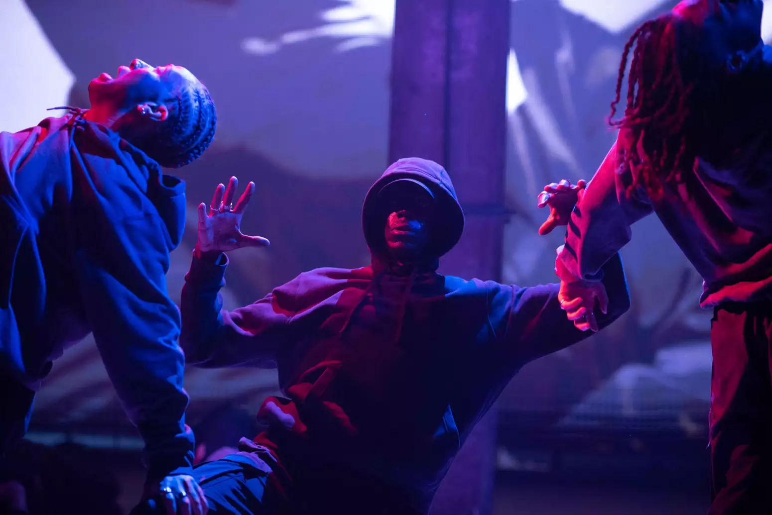Three dancers on stage during a production of Traplord