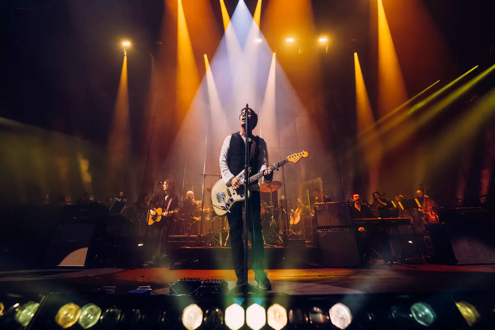 Johnny Marr performing on the Warehouse stage at Aviva Studios, singing and playing guitar