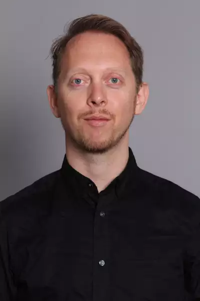 Frank Moon headshot on a grey background