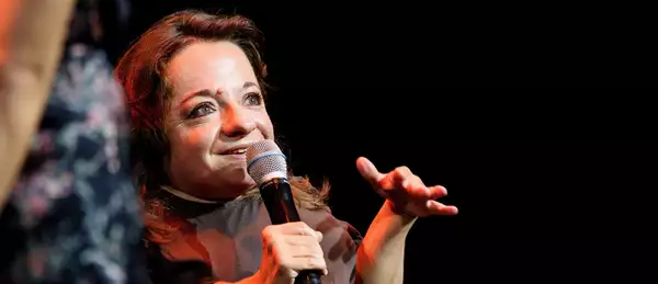 Chiara Bersani speaking on stage into a microphone