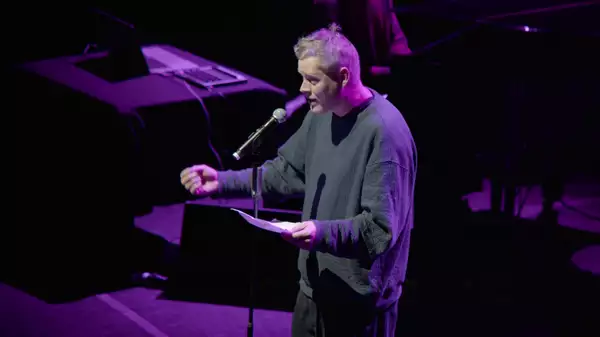 Max Porter performing on stage at Aviva Studios with purple lighting
