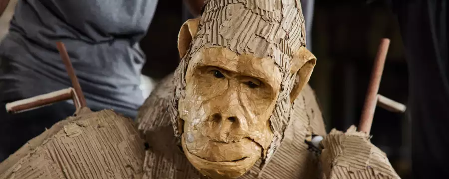 A close-up of a cardboard puppet of a gorilla