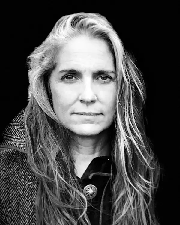 Black and white headshot of Christine Jones wearing a wool coat