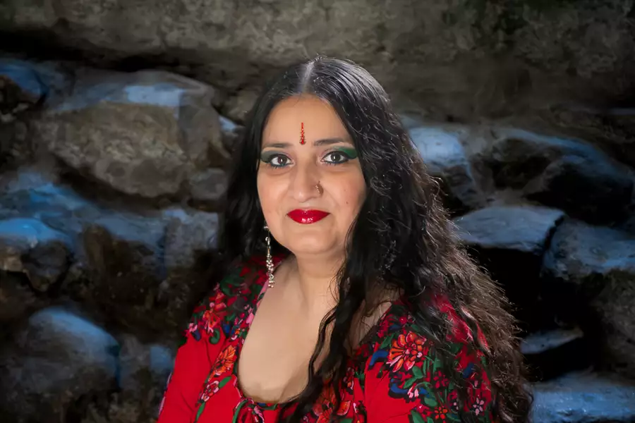 Headshot of Satnam Galsian in front of a stone wall