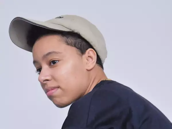 Photo of Lavender Rodriguez - one of the Factory Sounds cohort for 2023 - wearing a beige cap and navy t-shirt