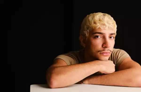 Headshot of Adam Ali on a black background