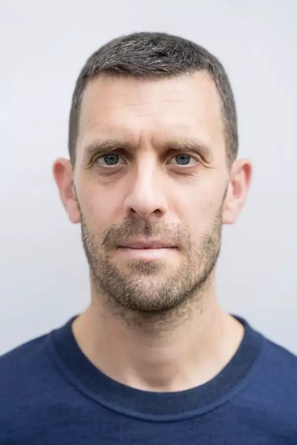 Headshot of Jonathan Goddard wearing a blue top