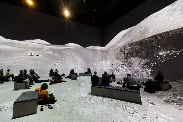 People watching The Moonwalkers, showing a scene on the moon