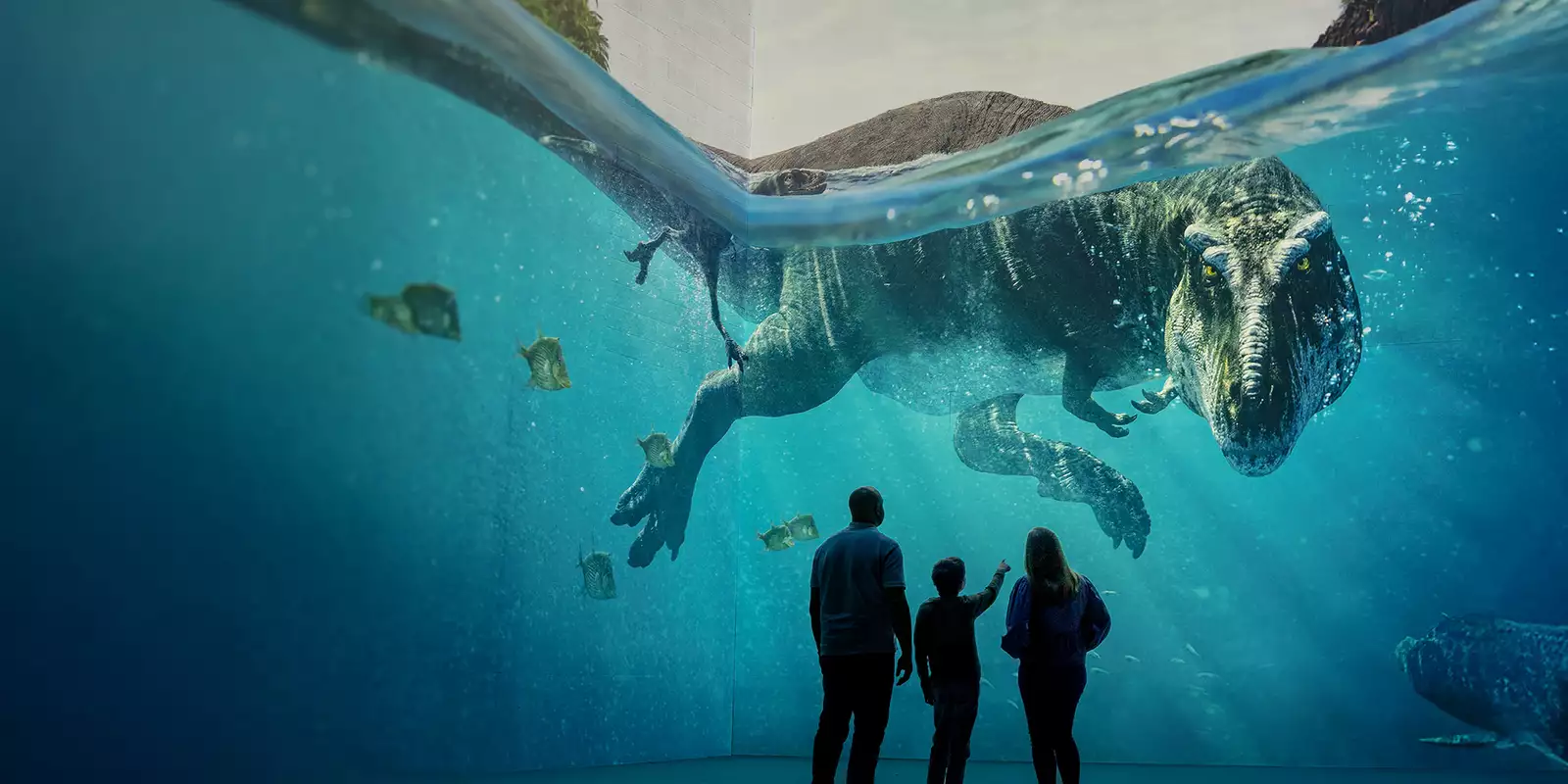 Three people looking at a giant dinosaur swimming in Lightroom