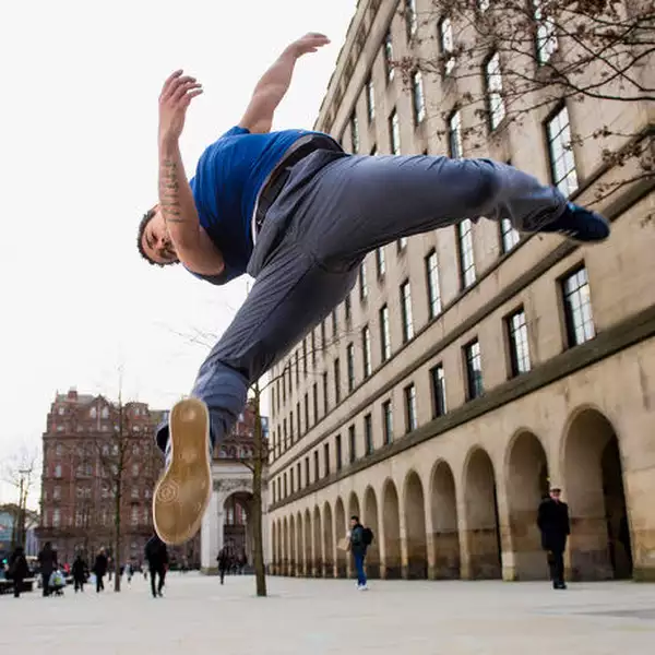 Photo of somebody doing a back flip in the street
