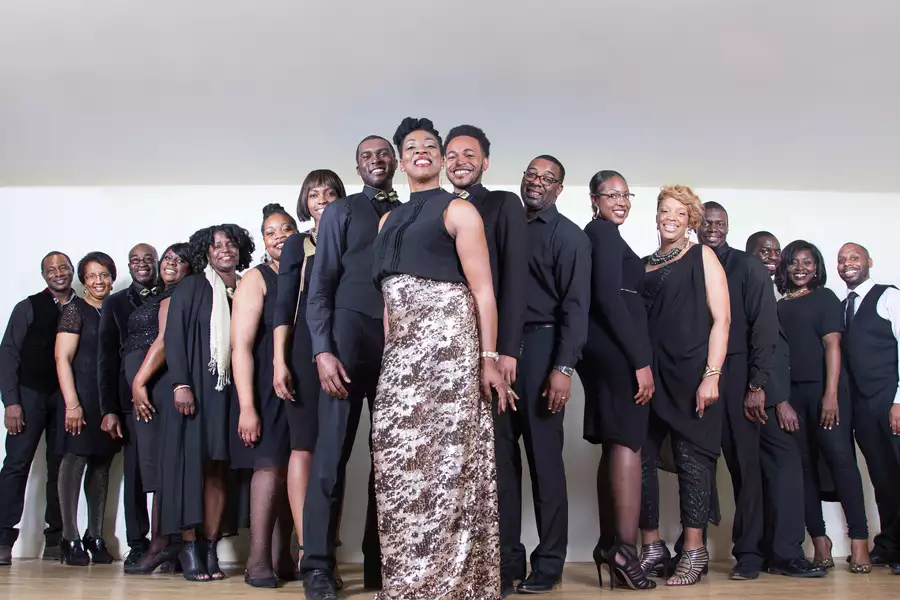 Members of AMC Gospel Choir stood in line wearing all black smart clothes and smiling