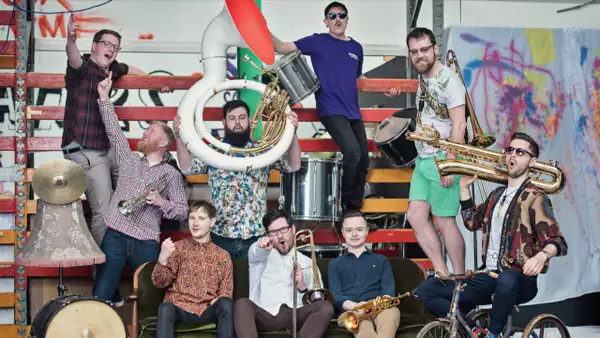Nine members of Young Pilgrims posing with their brass instruments
