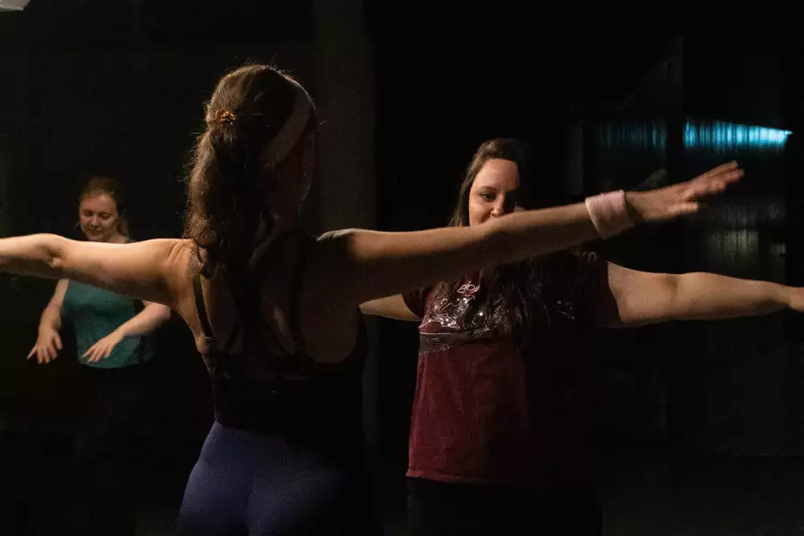 Three people taking part in an aerobics class