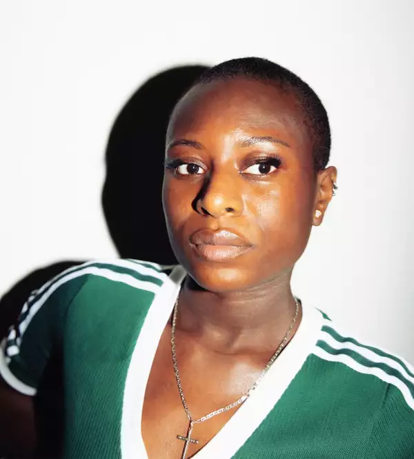 Elizabeth Bisuga wearing a green and white Adidas top, on a white background