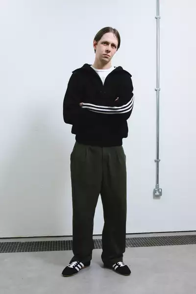 Yaraslav Prytula wearing a black Adidas jacket, shoes and green trousers
