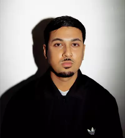 Hriday Das wearing a black Adidas zipped jumper on a white background