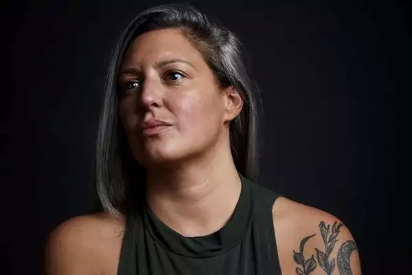 Headshot of Chimene Suleyman on a black background