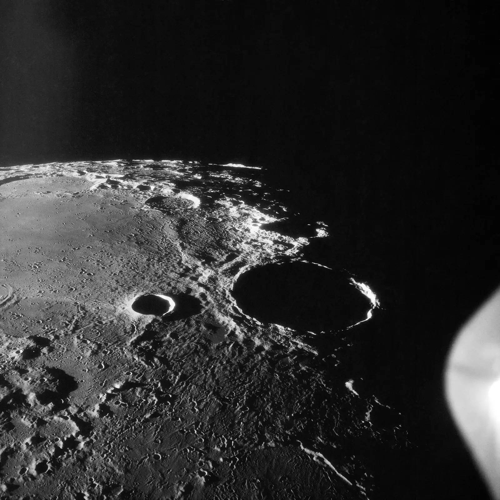 A black and white photograph of a crater on the moon