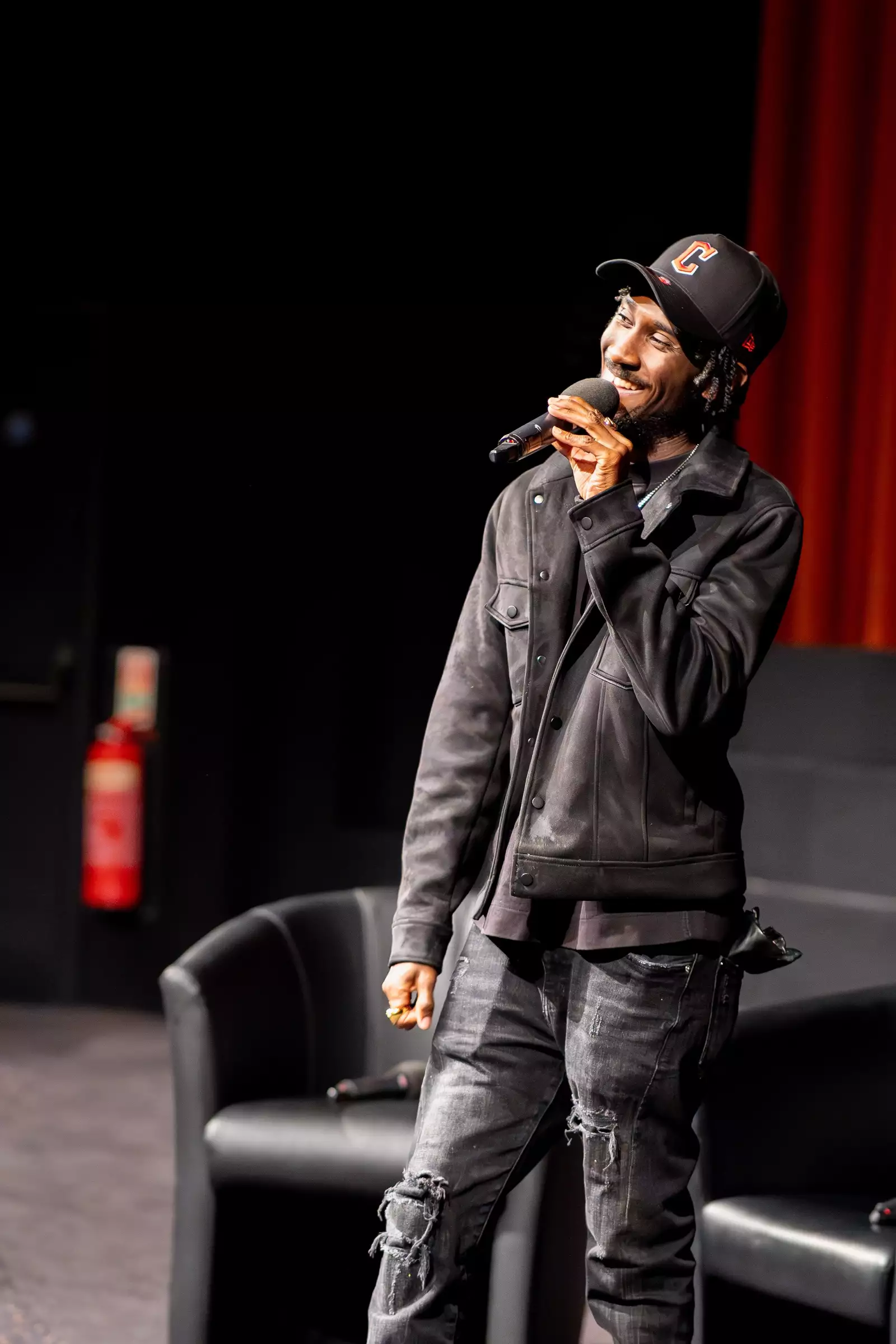 A photo of photographer Cephas Williams speaking as a guest speaker for Black Out
