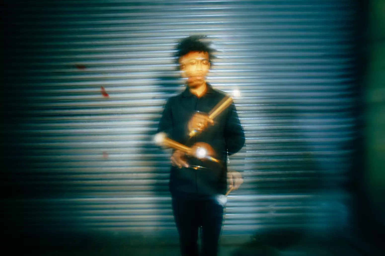 Obeka photographed with drumsticks by Marieke Macklon