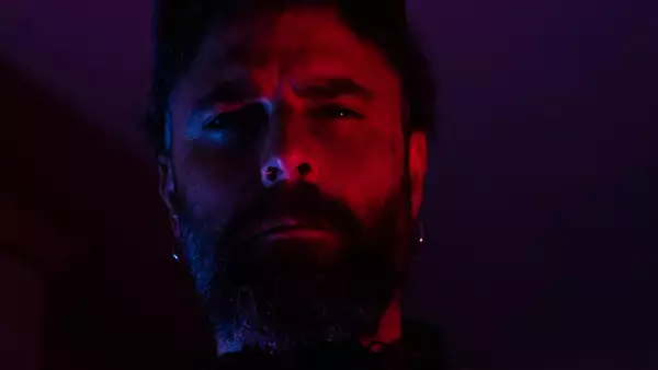 Dark and moody photo with red lighting of DJ Chafik