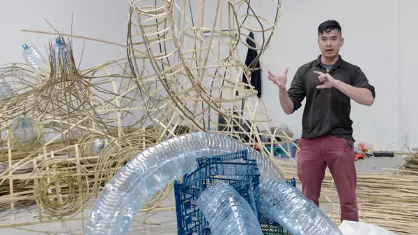 Artist Leeroy New with one of his sculptures
