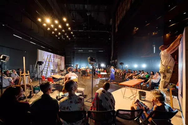 A group of people watching a performance of 12 Last Songs