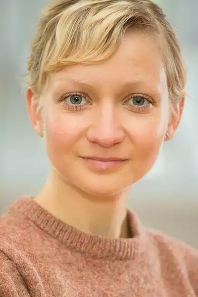 Headshot of Teele Uustani wearing a light red jumper