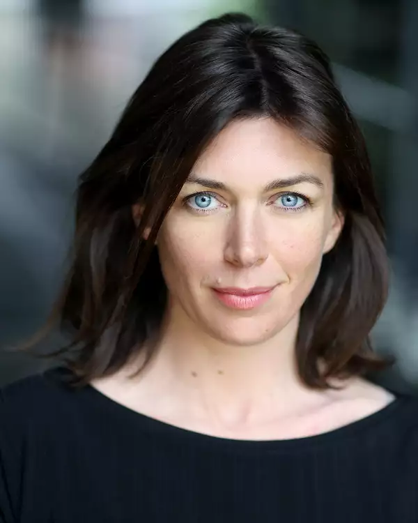 Headshot of Claudia Harrison wearing a black top