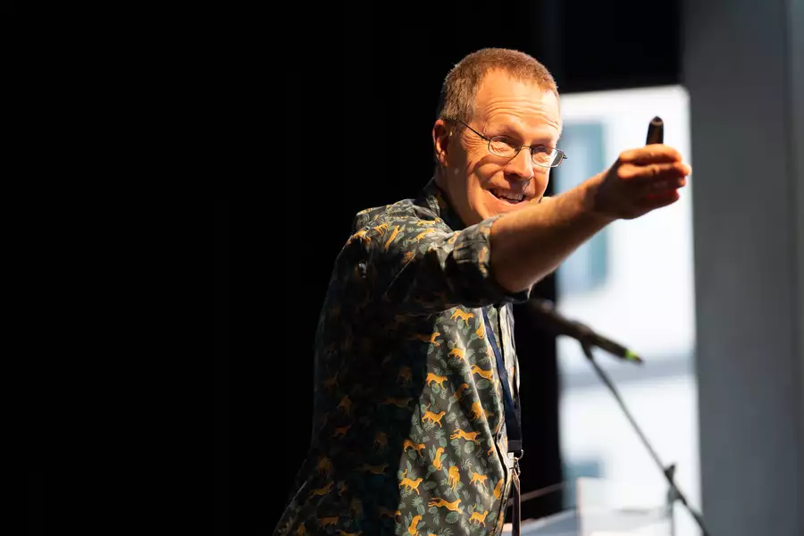 Graham Smith stood on stage and pointing