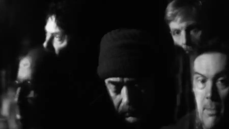 Black and white blurred photograph of the faces of five members of Tindersticks