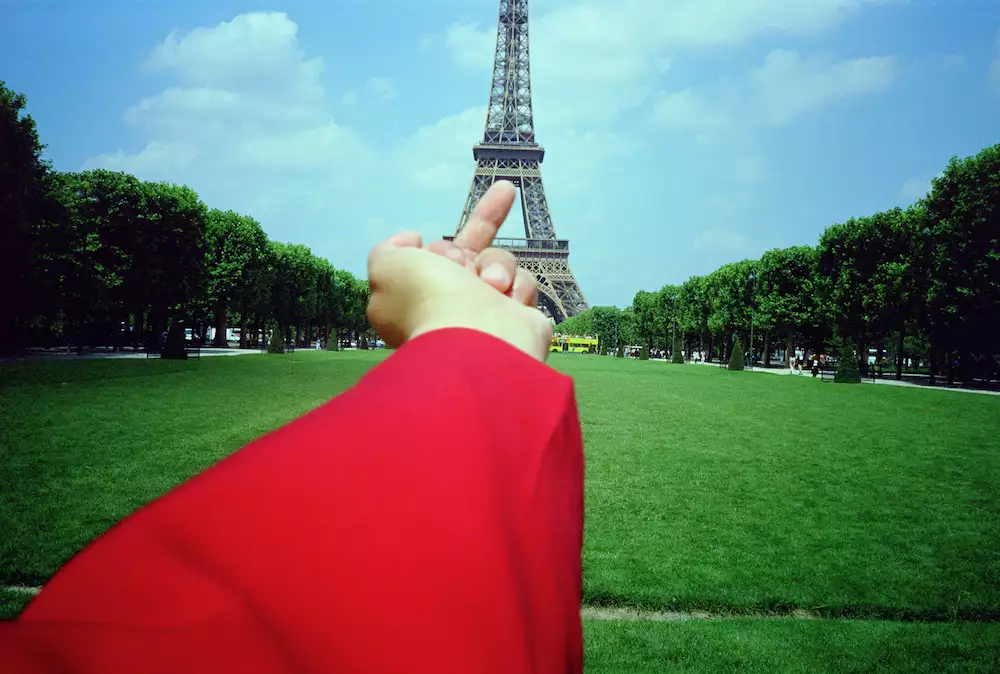 Photograph of Ai Weiwei putting his middle finger up to the Eiffel Tower