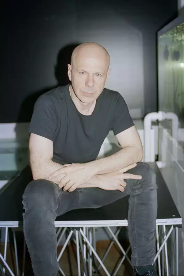 Philippe Parreno wearing all black, sat down